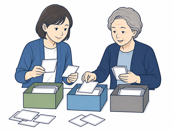 写真を三つの箱に分け、家族で残し方を相談するイラスト